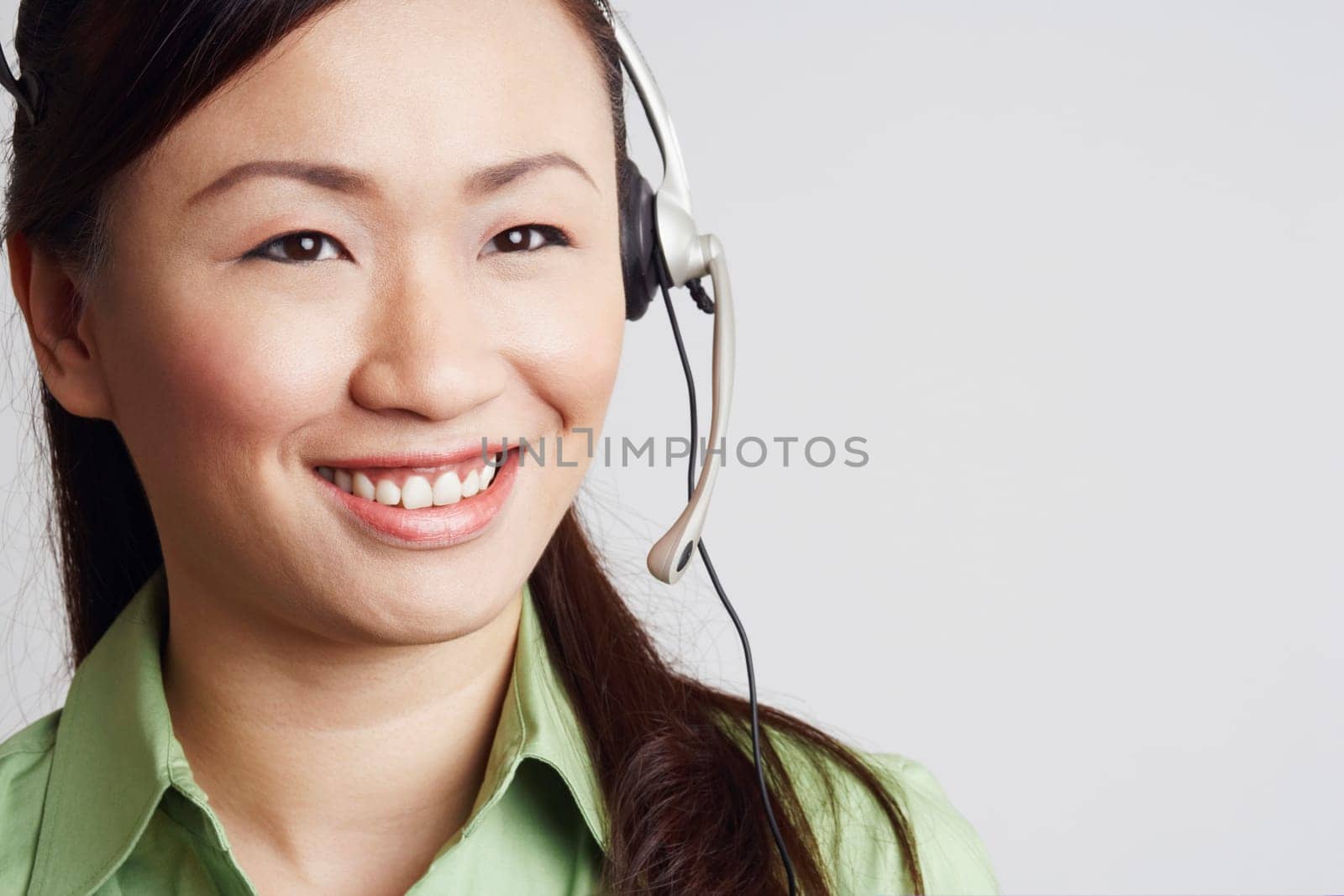 Close-up of a female customer service representative looking away and smiling