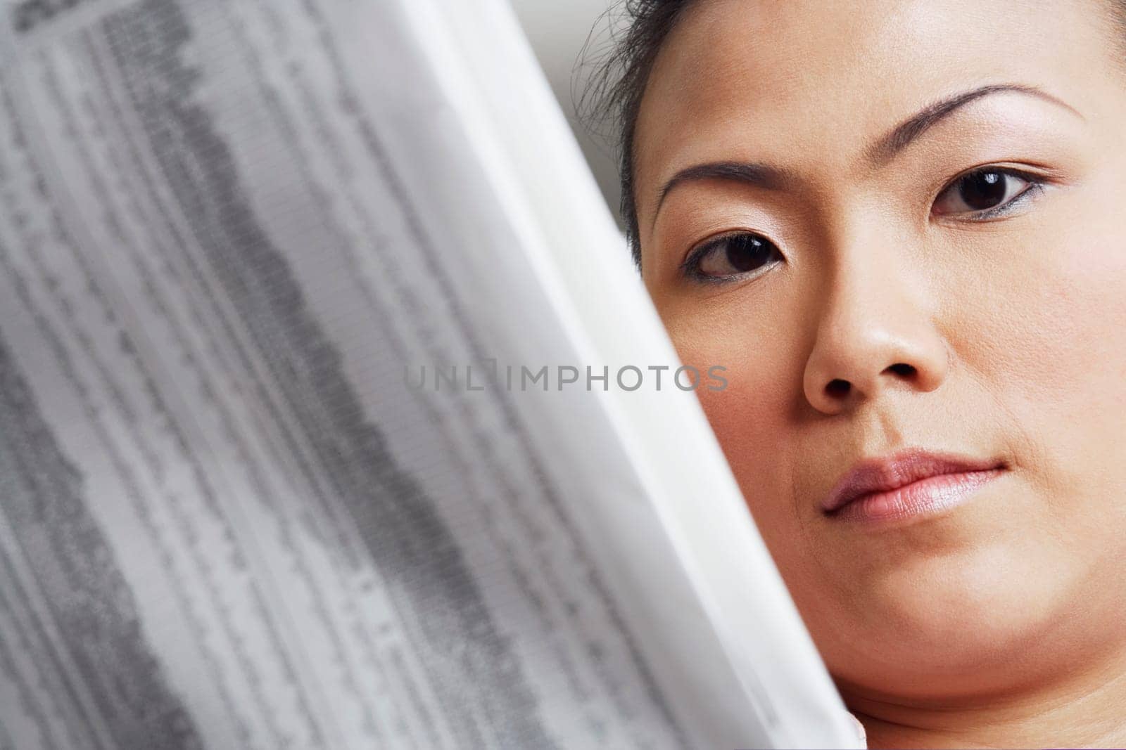 Portrait of a businesswoman holding a financial newspaper