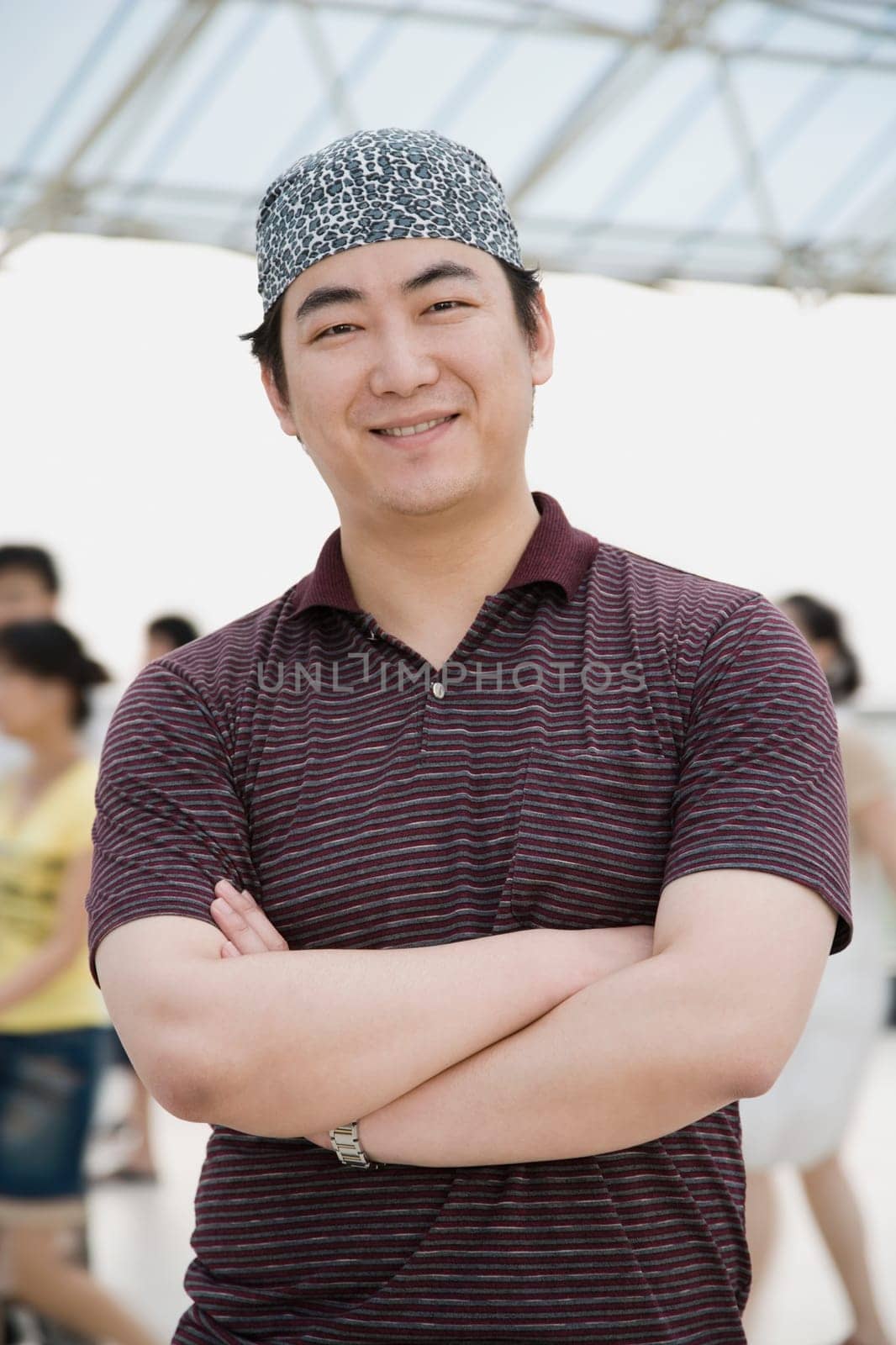 Portrait of a mid adult man standing with his arms crossed and smiling