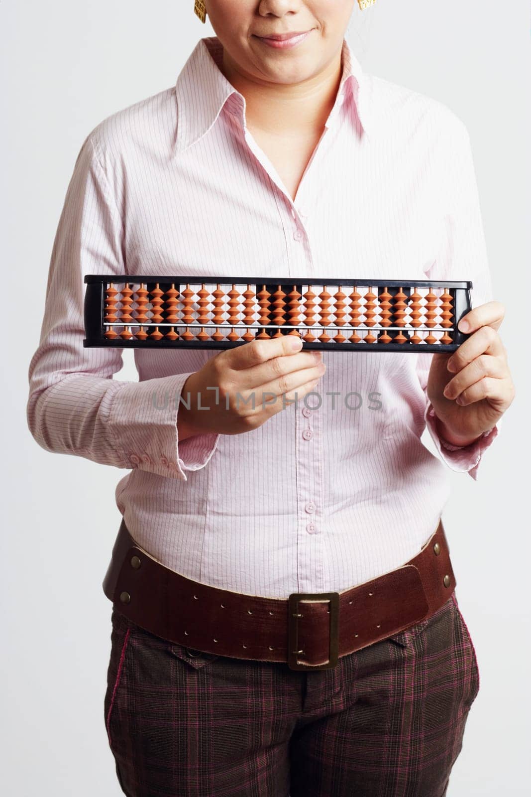 Mid section view of a businesswoman holding an abacus