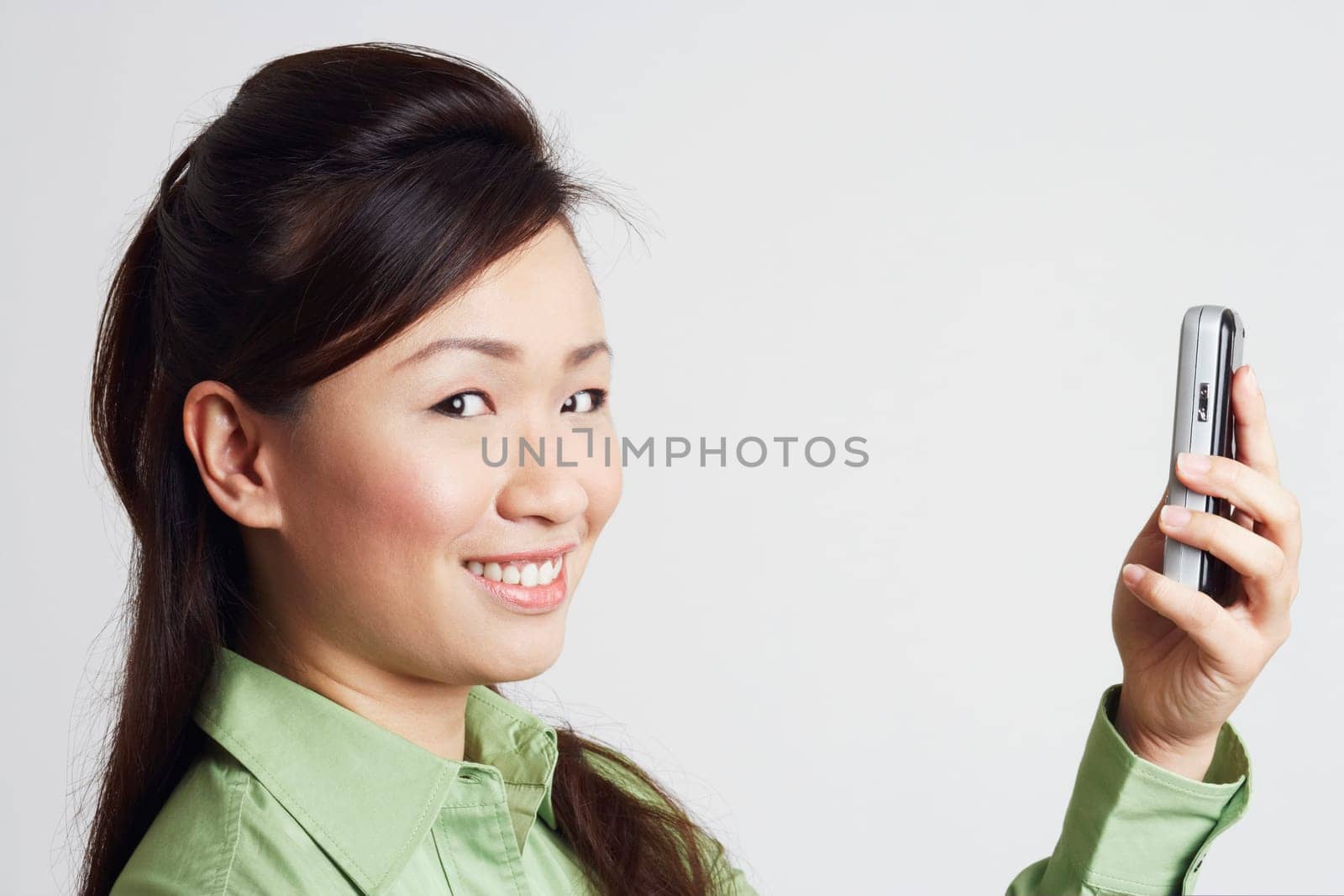 Portrait of a young woman holding a mobile phone