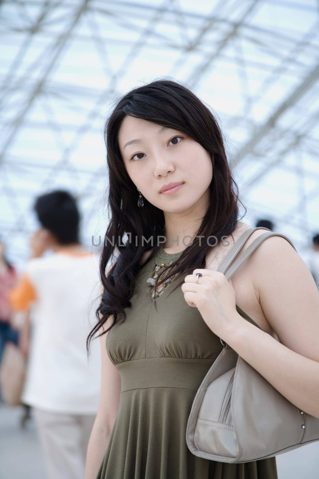 Portrait of a young woman standing in a corridor