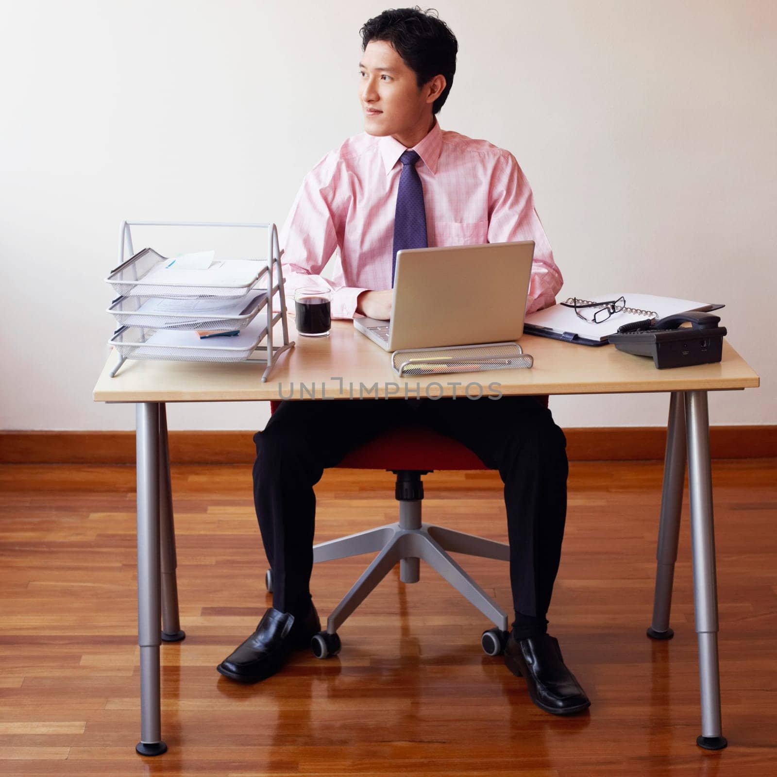 Businessman sitting in an office and thinking