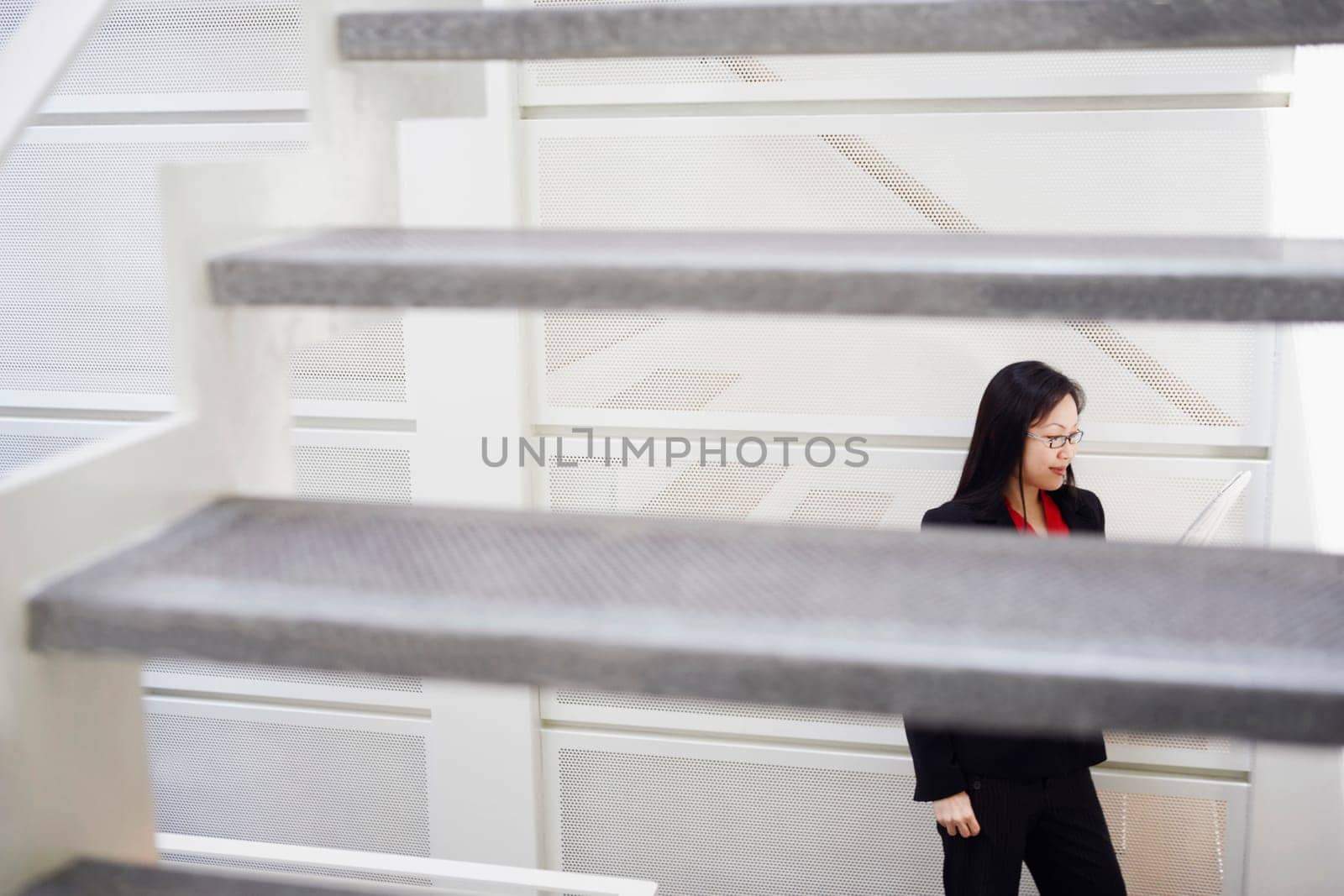 High angle view of a businesswoman reading a newspaper
