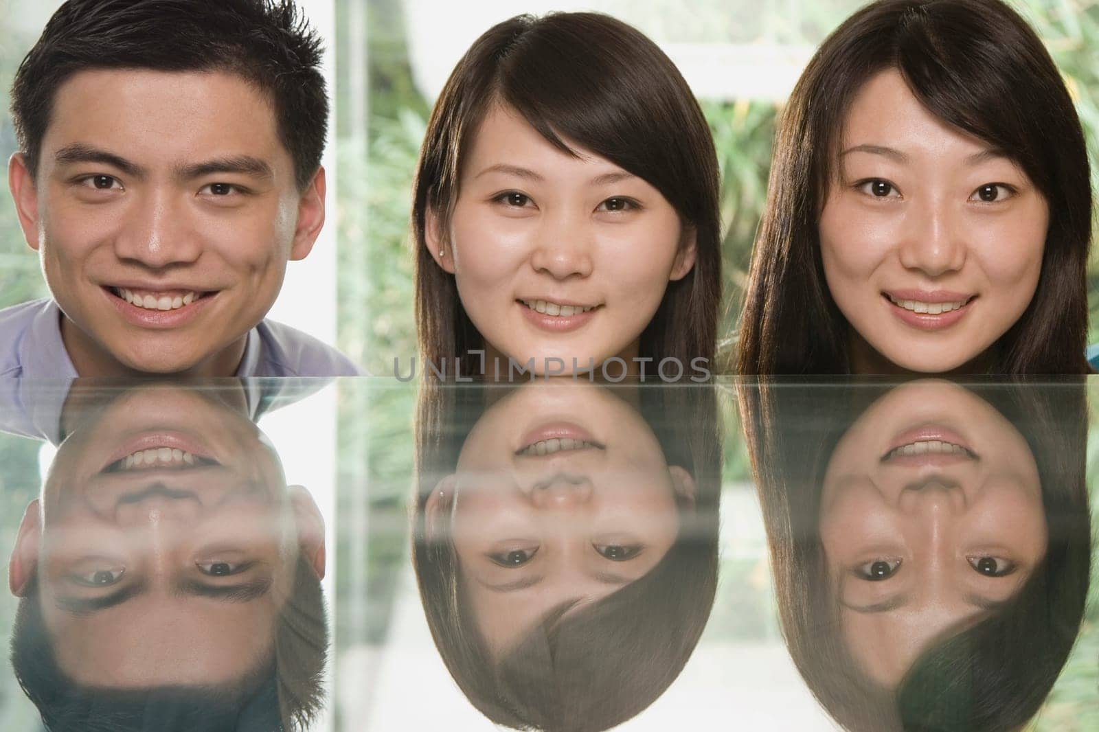 Portrait of office workers resting their heads on a table and smiling