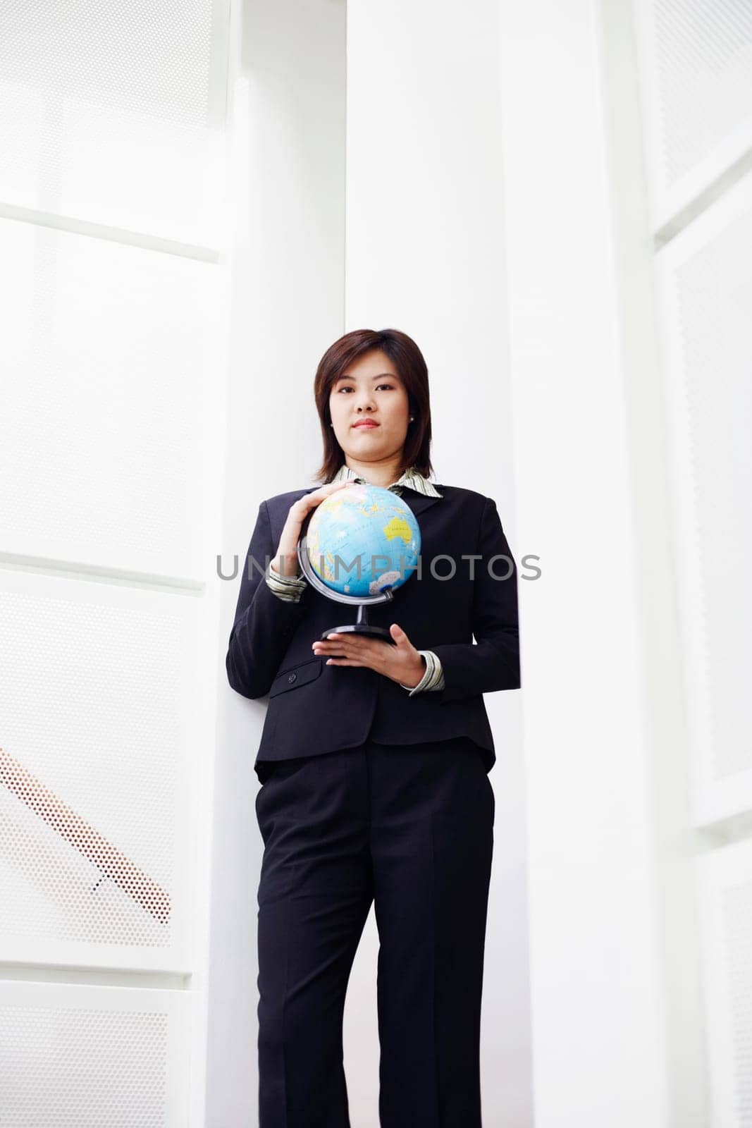Portrait of a businesswoman holding a globe