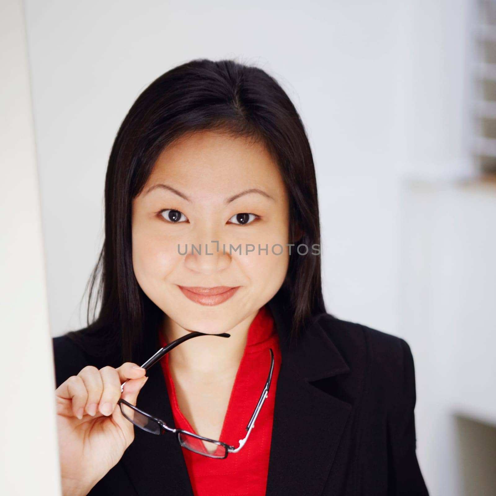 Portrait of a businesswoman holding a newspaper and smiling