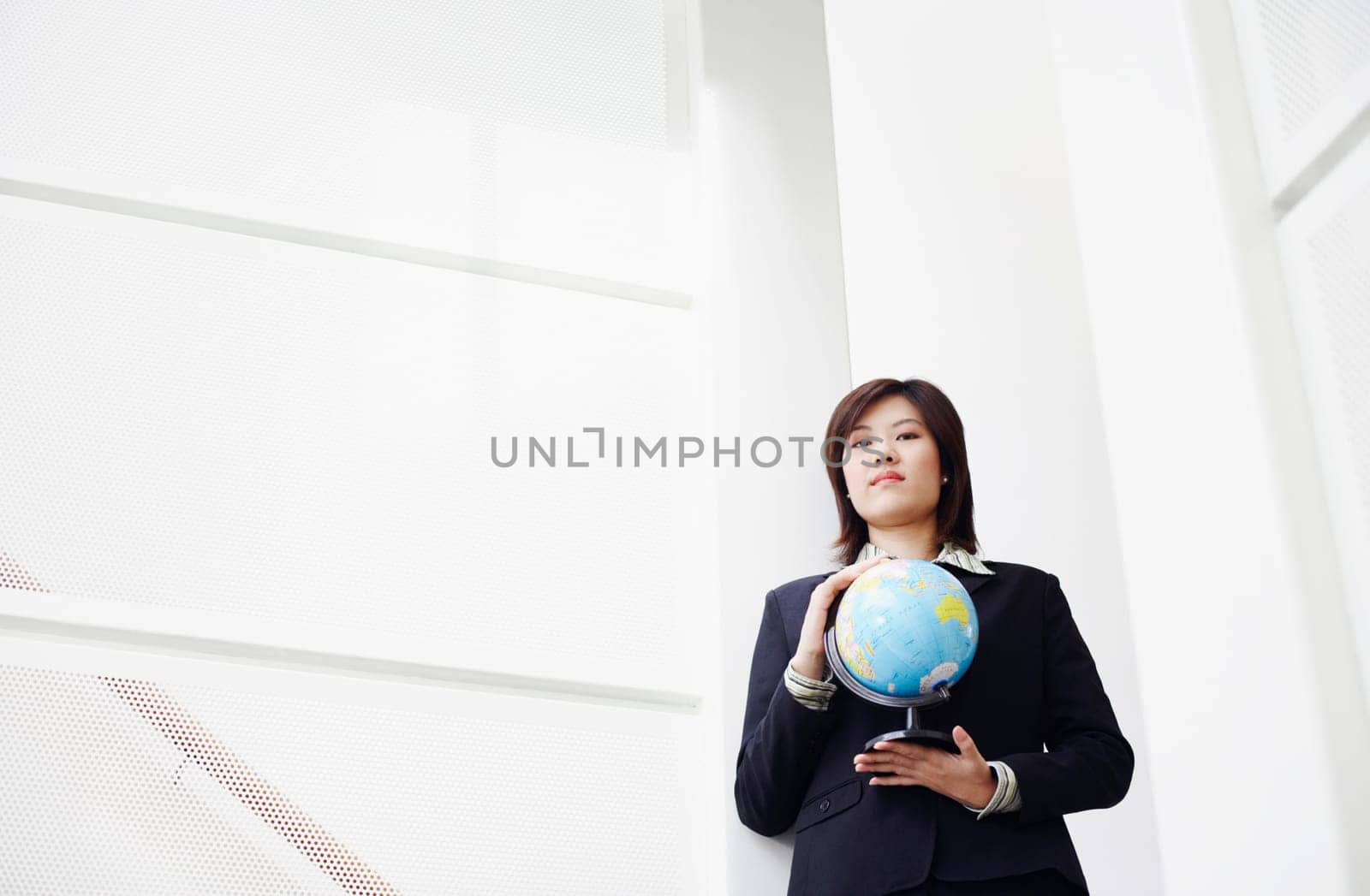 Portrait of a businesswoman holding a globe