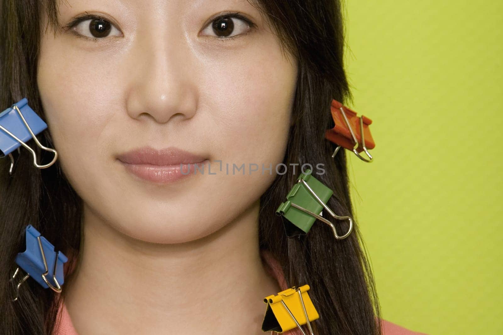 Portrait of a young woman with paper clips in her hair