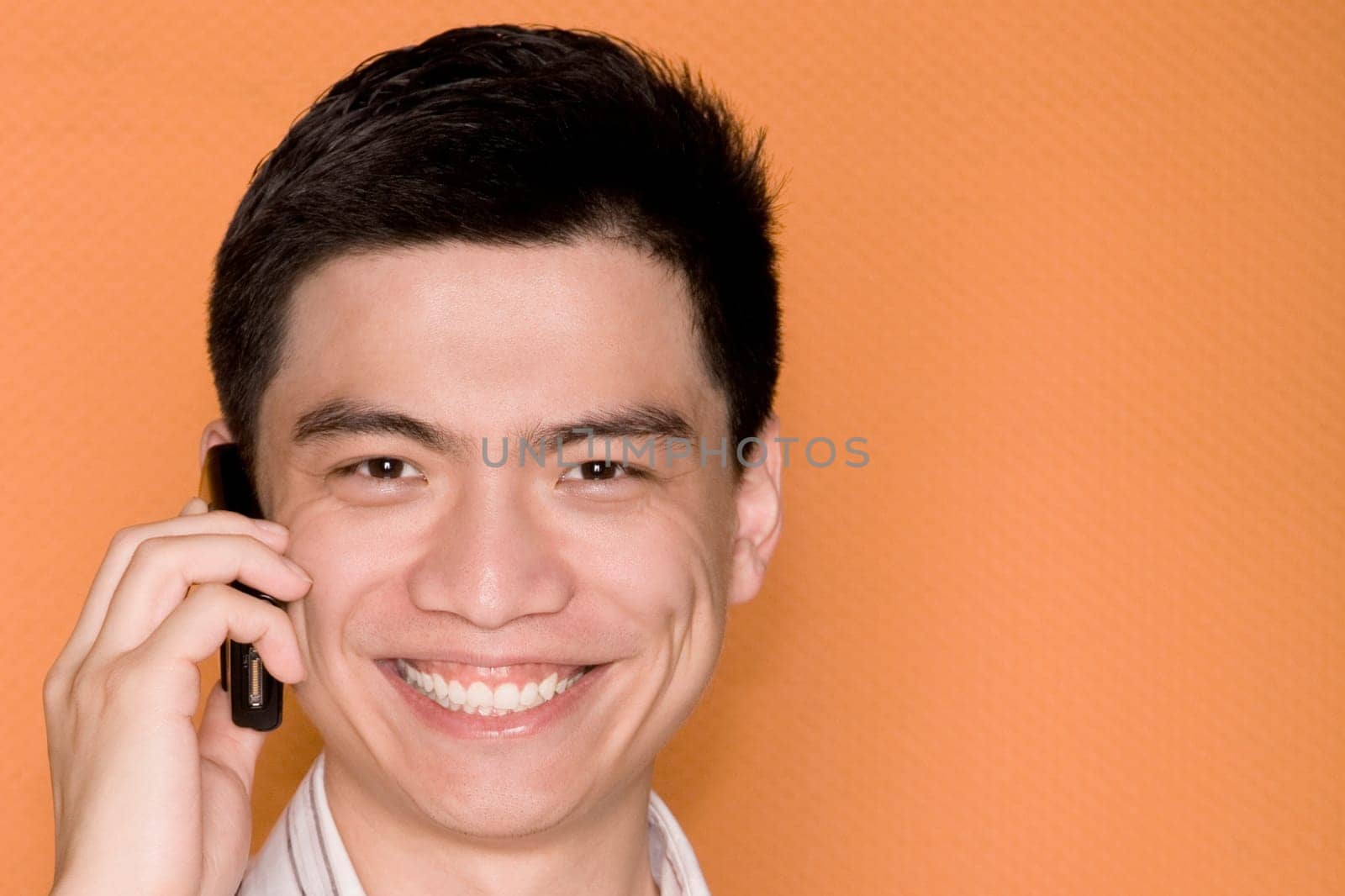 Portrait of a male office worker talking on a mobile phone and smiling