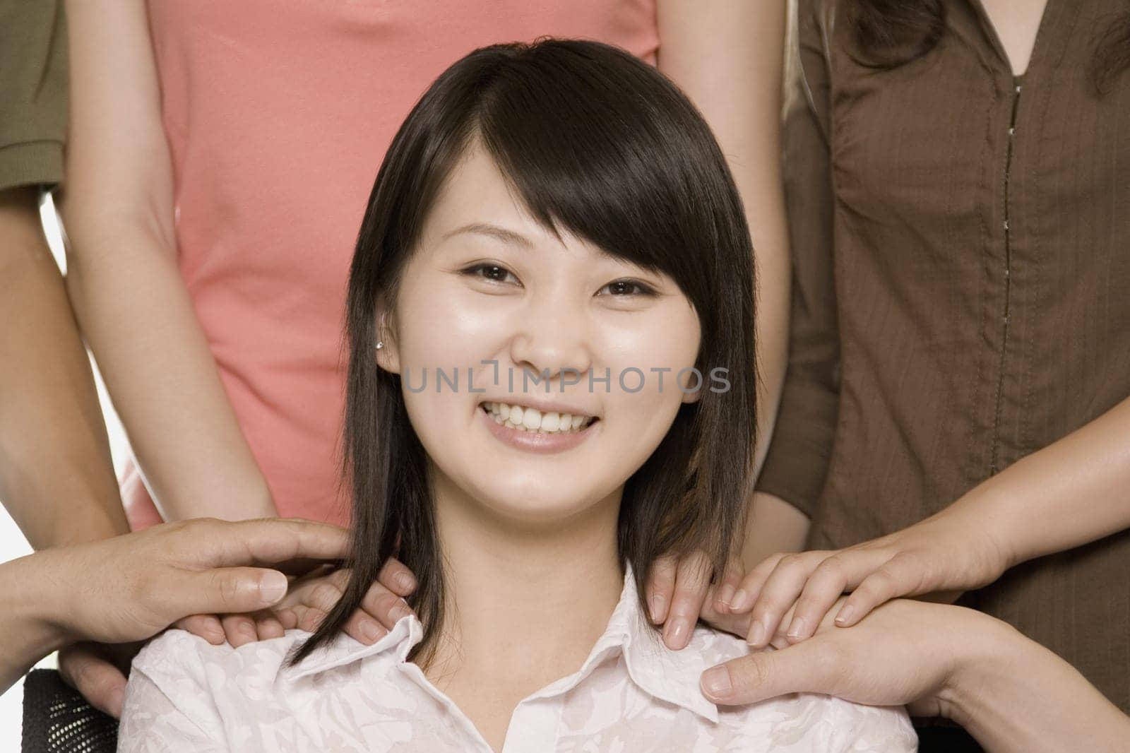 Portrait of a young woman being appreciated by her colleagues