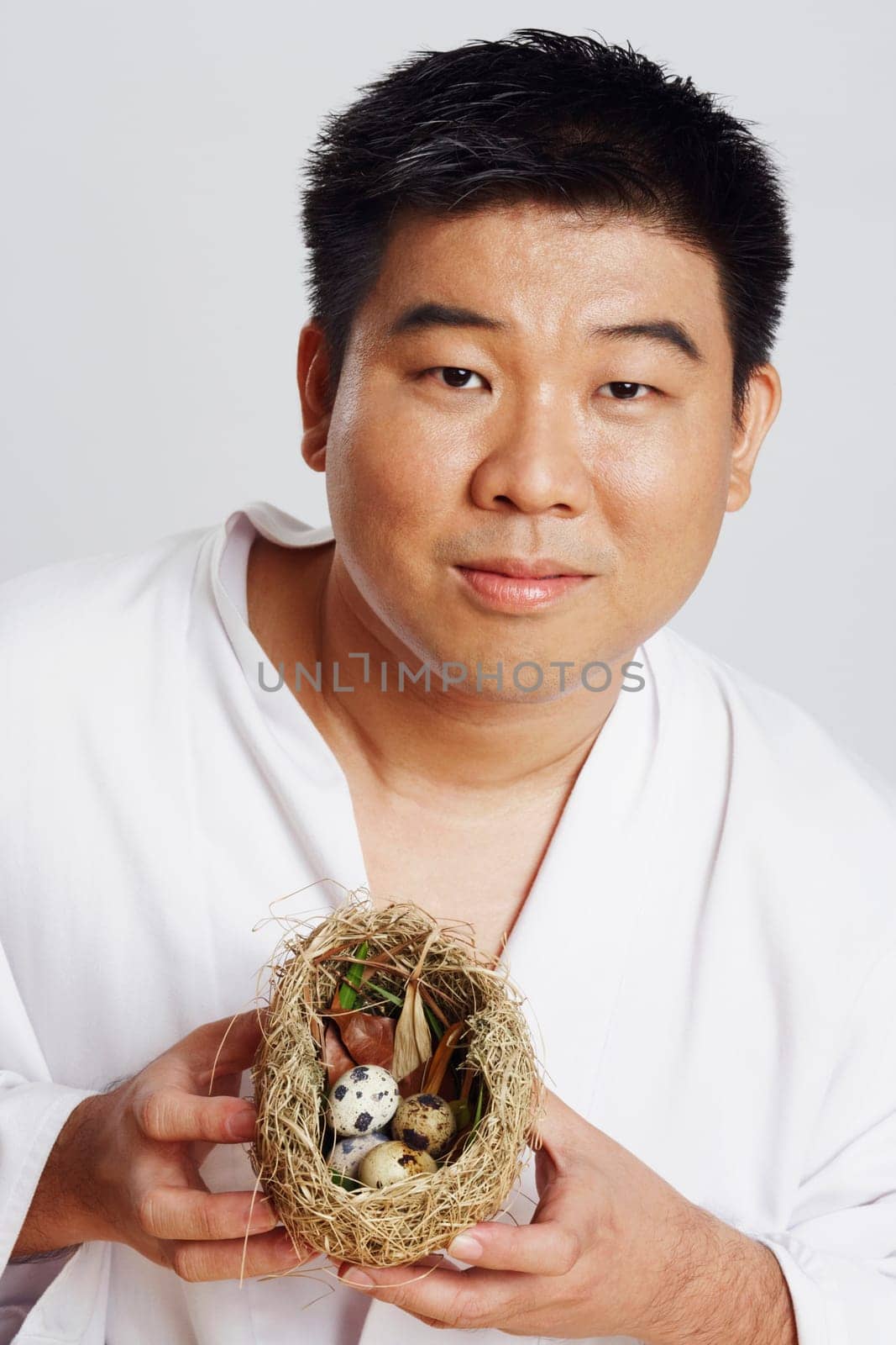 Portrait of a mid adult man holding a birdŽs nest