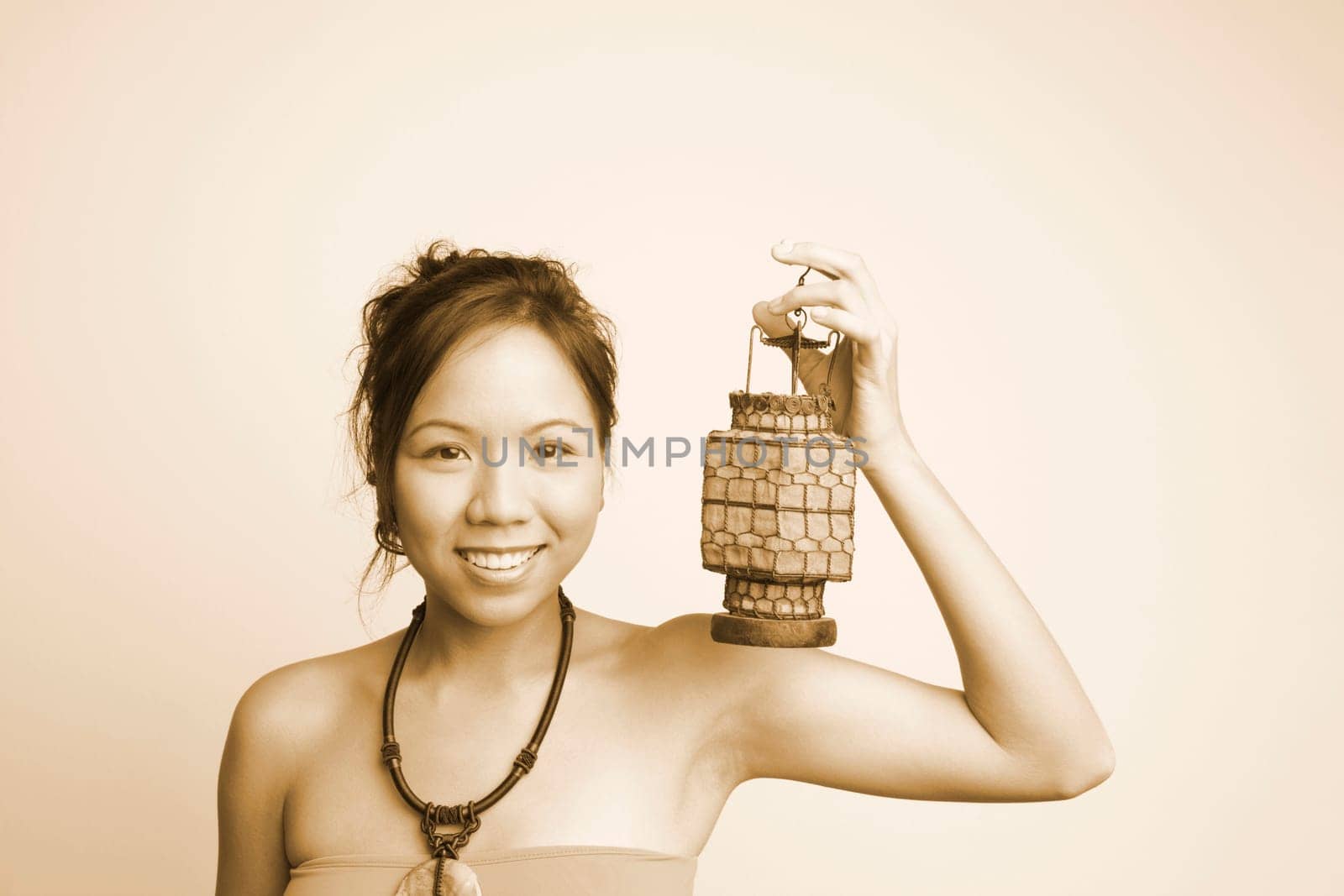 Portrait of a young woman holding a lantern and smiling