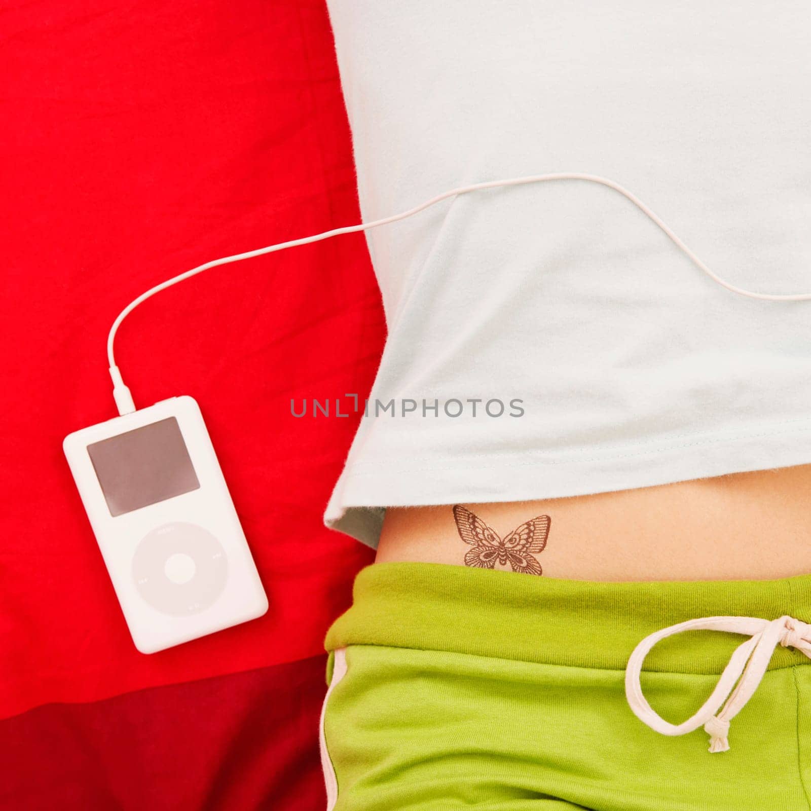 Mid section view of a woman with an MP3 player