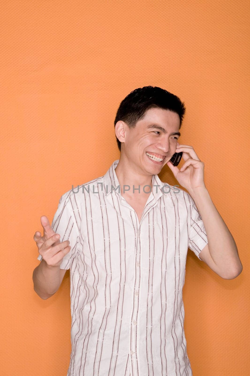 Male office worker talking on a mobile phone and smiling