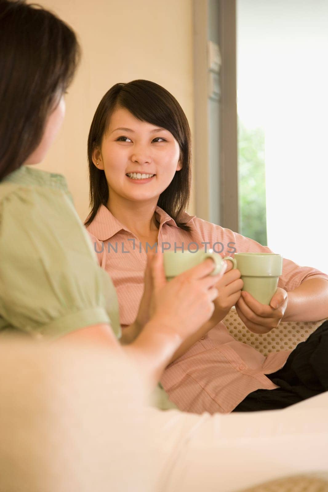 Two young women holding coffee cups