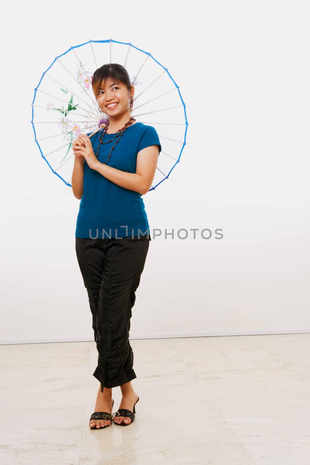 Young woman standing with a parasol