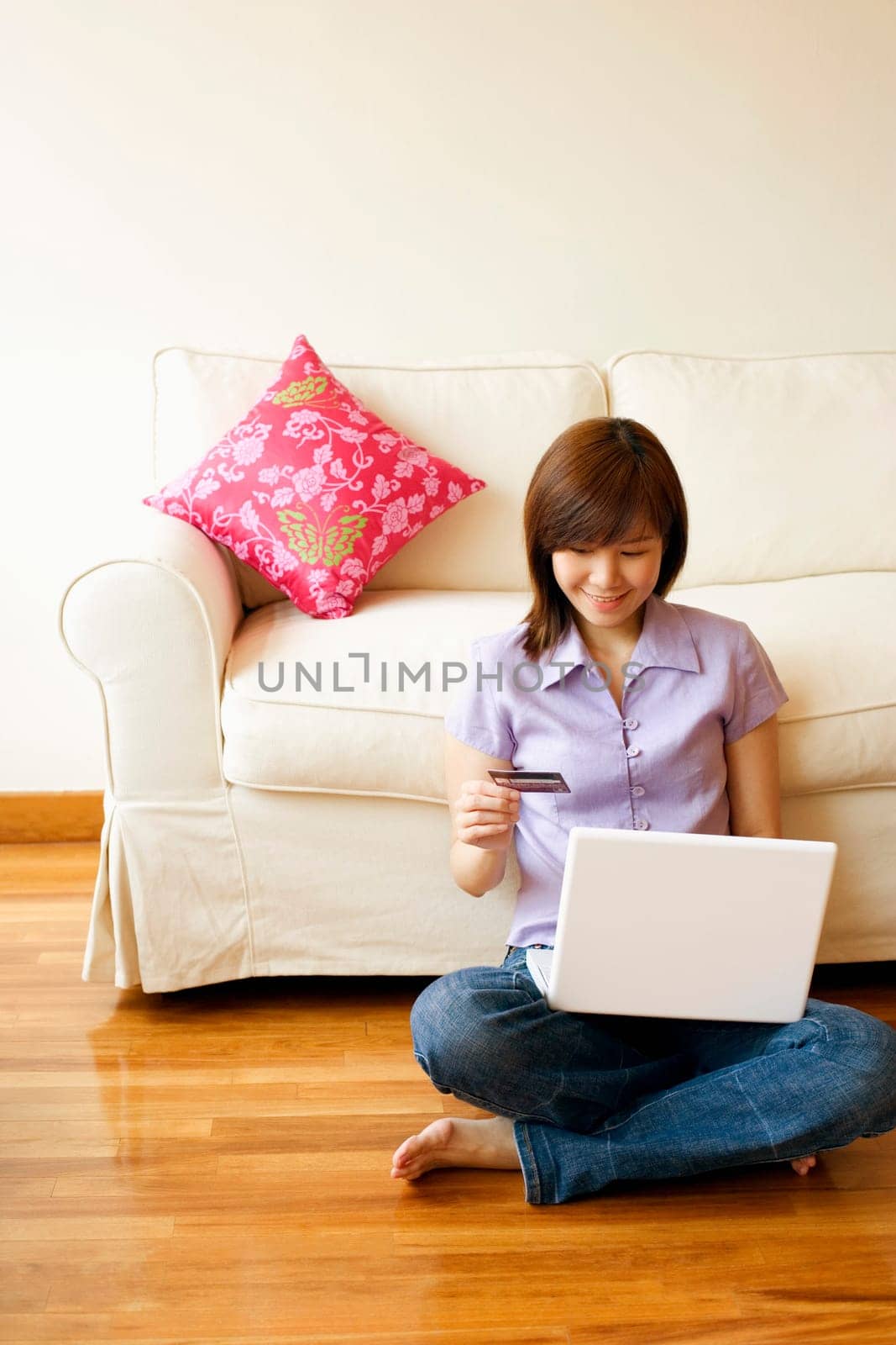 Young woman shopping online with a credit card