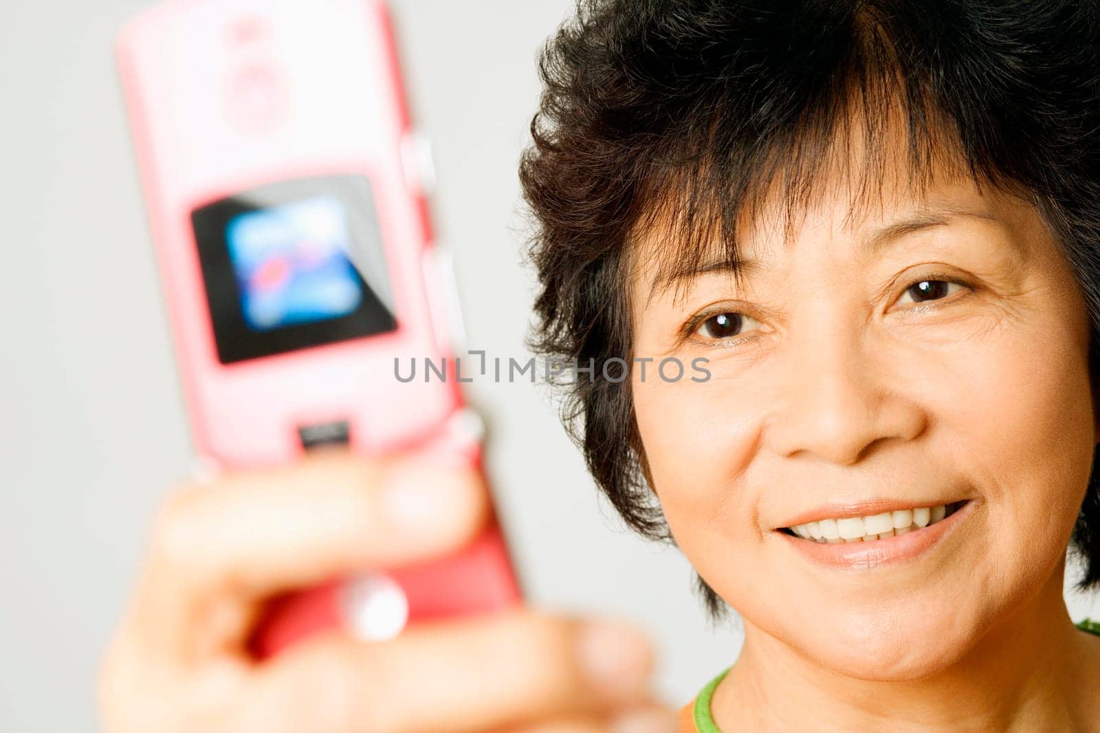 Close-up of a mature woman holding a mobile phone