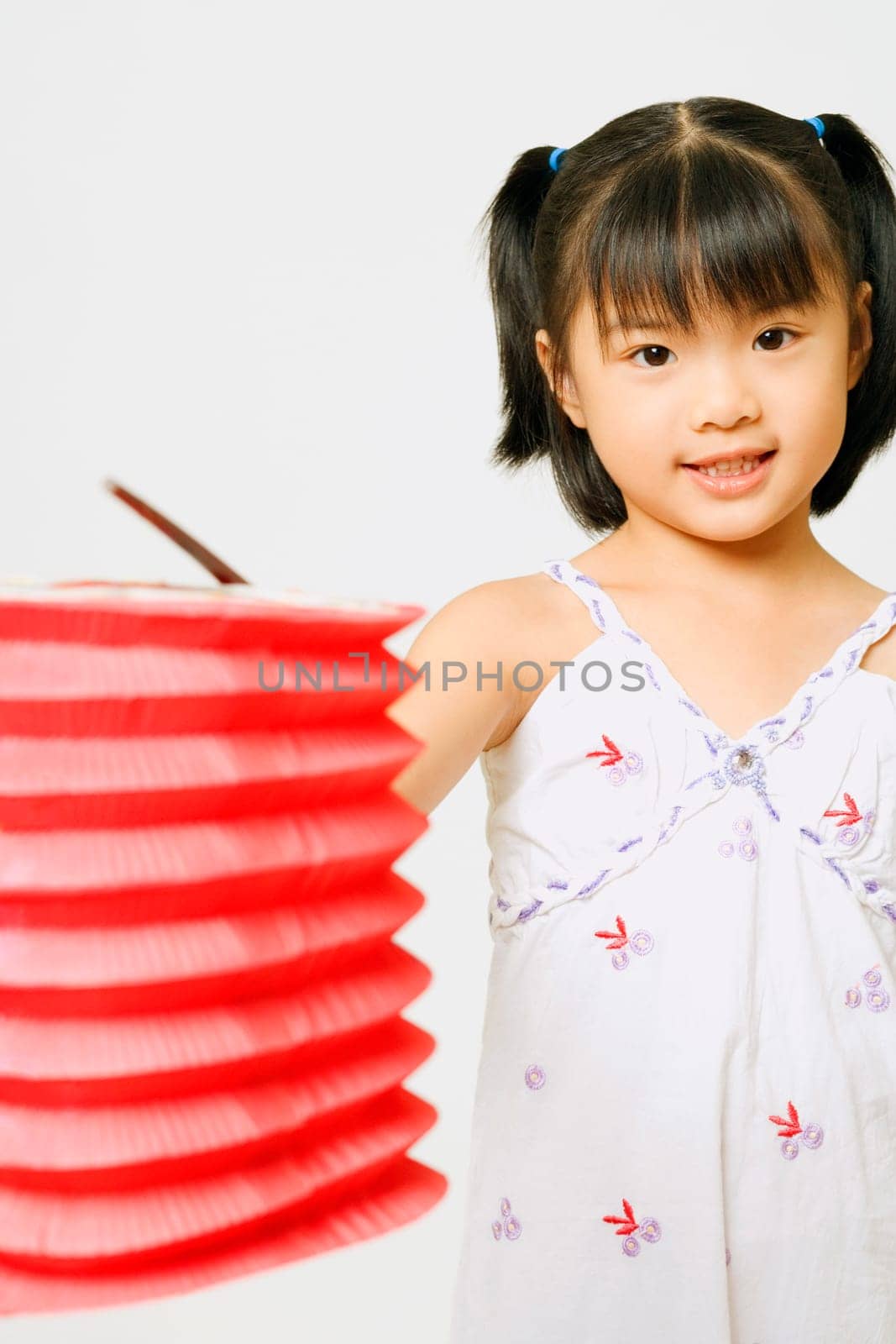 Portrait of a girl standing and holding a Chinese lantern