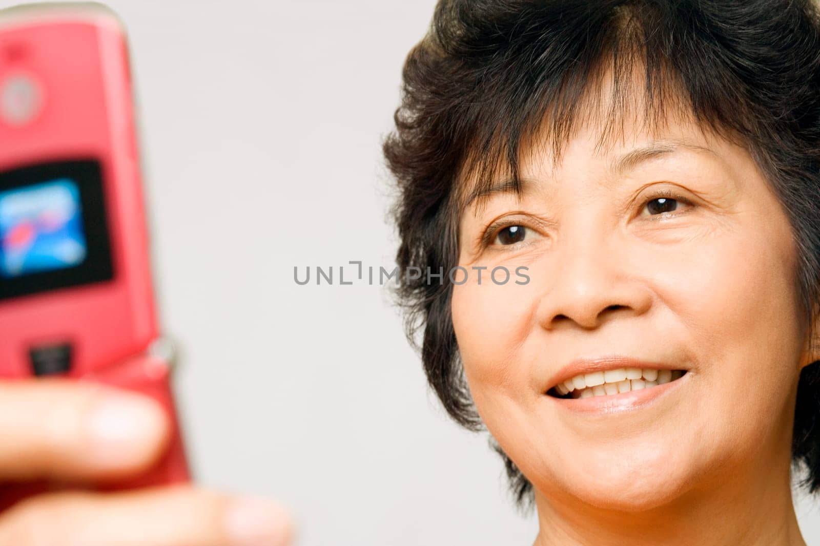Close-up of a mature woman holding a mobile phone