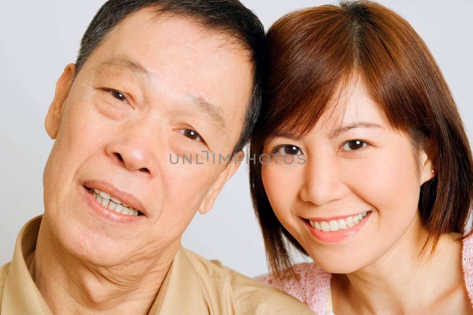 Portrait of a senior man with his daughter smiling