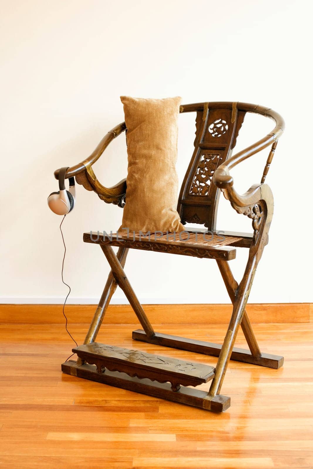 Cushion with headphones on a folding chair