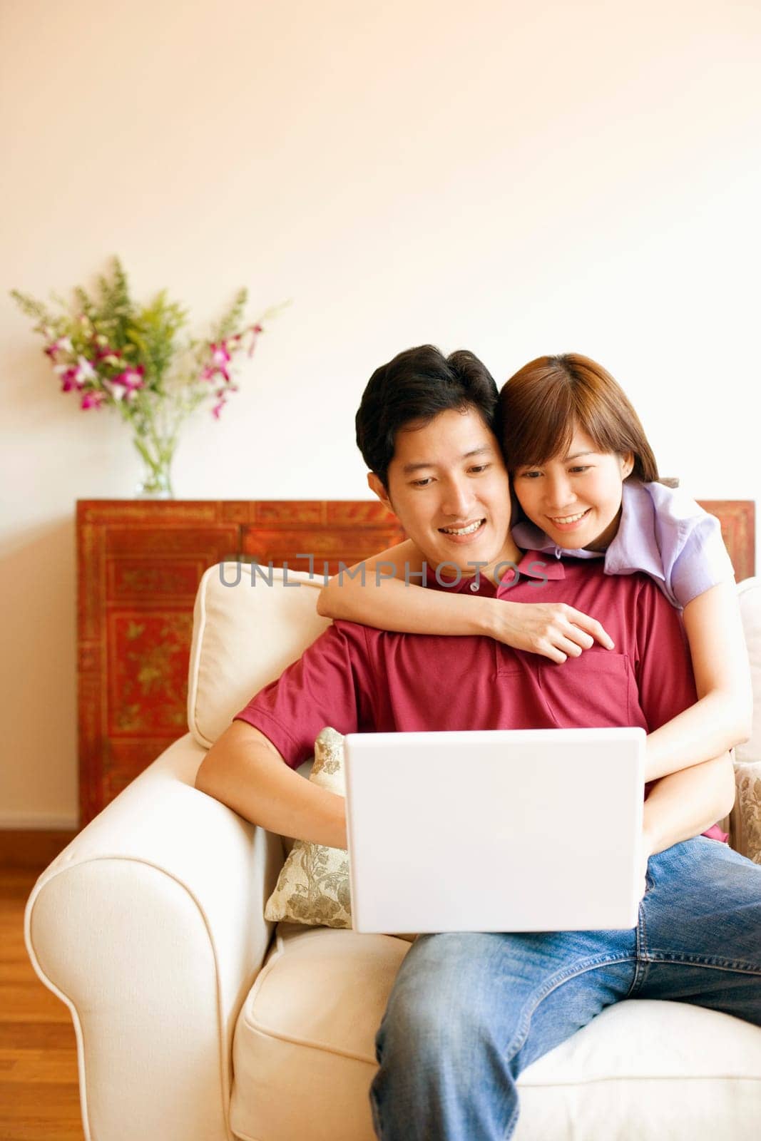 Young couple using a laptop and smiling