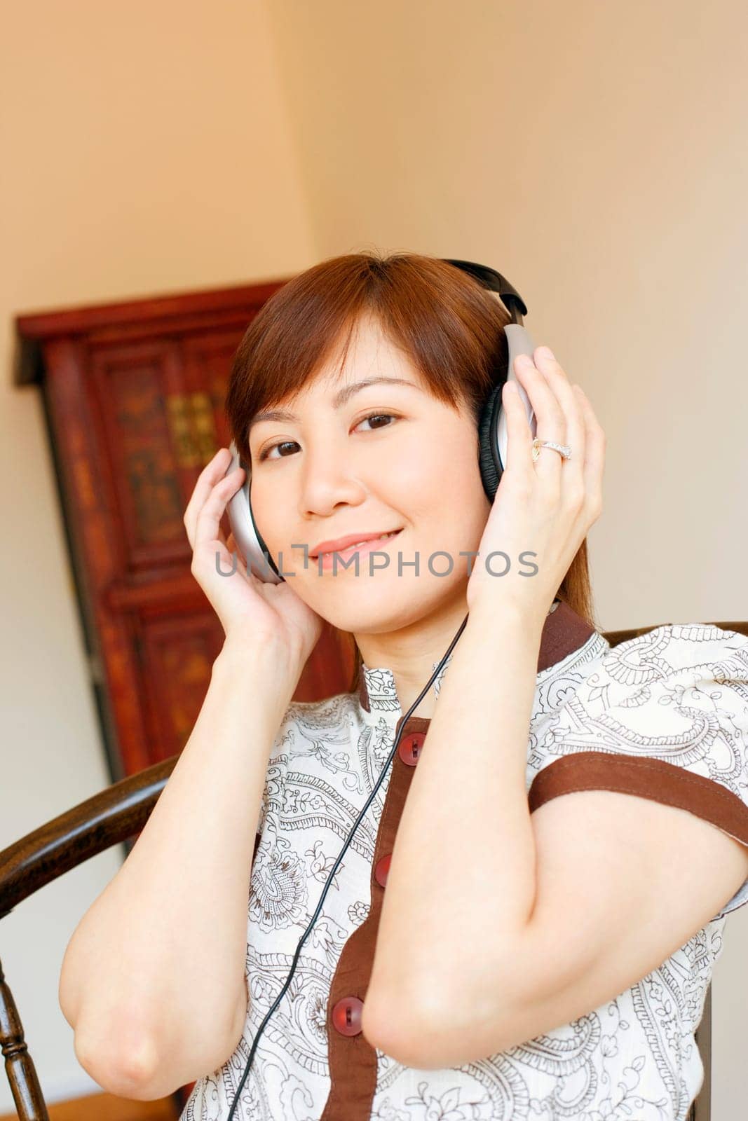 Portrait of a young woman wearing headphones and listening to music