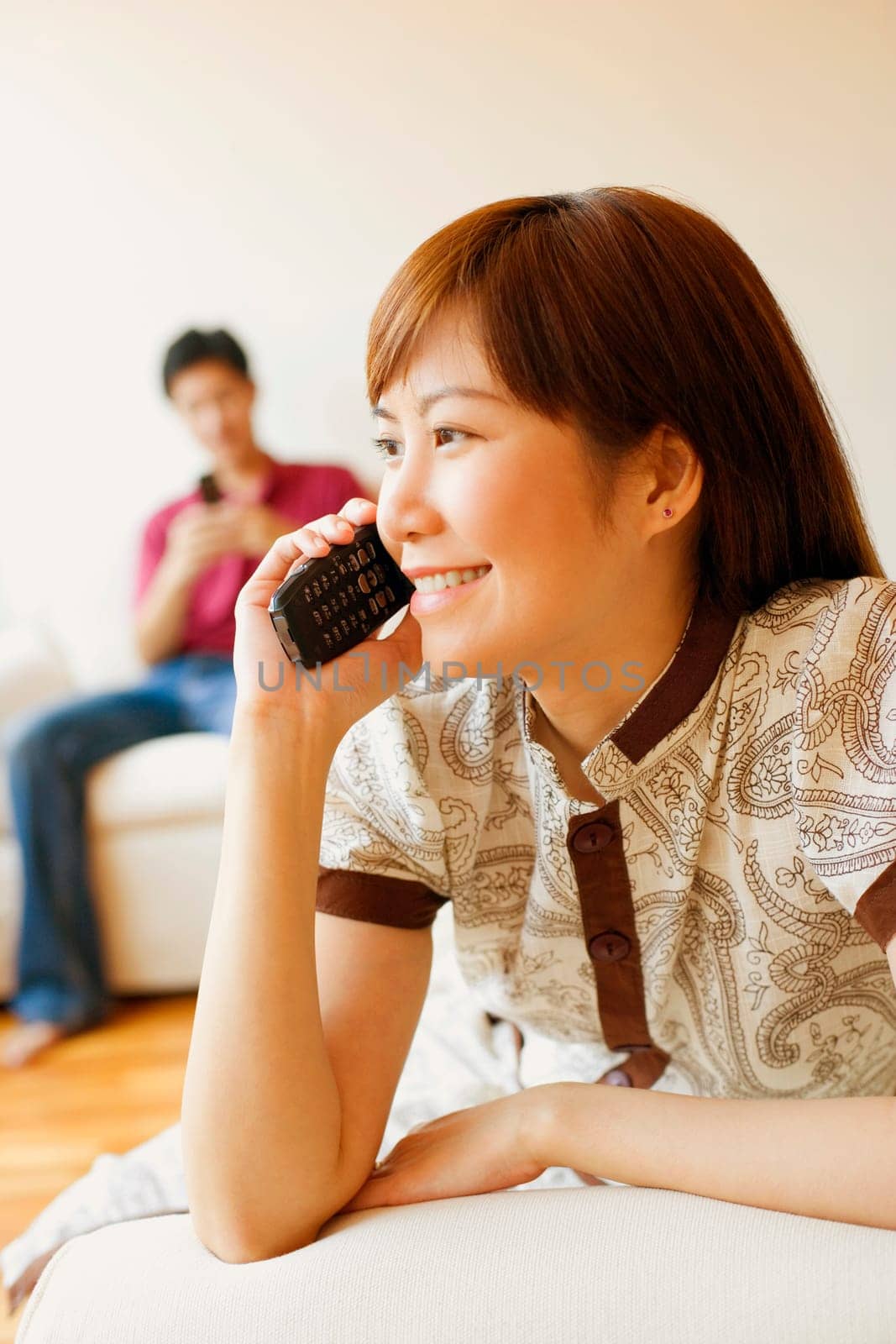 Close-up of a young woman talking on a mobile phone and smiling