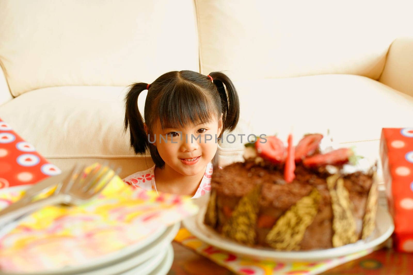 Girl smiling and looking at a cake