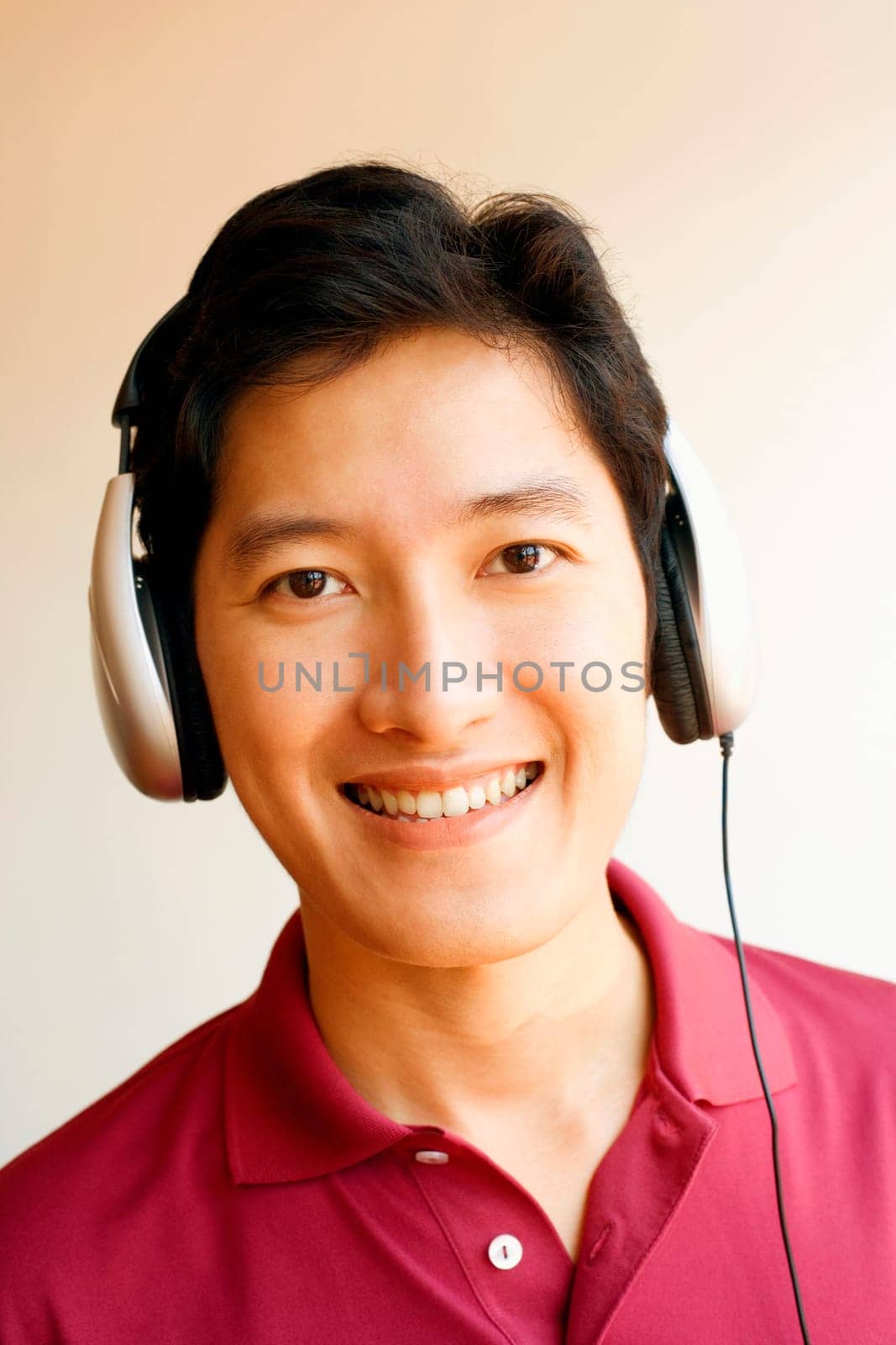Portrait of a young man wearing headphones and listening to music