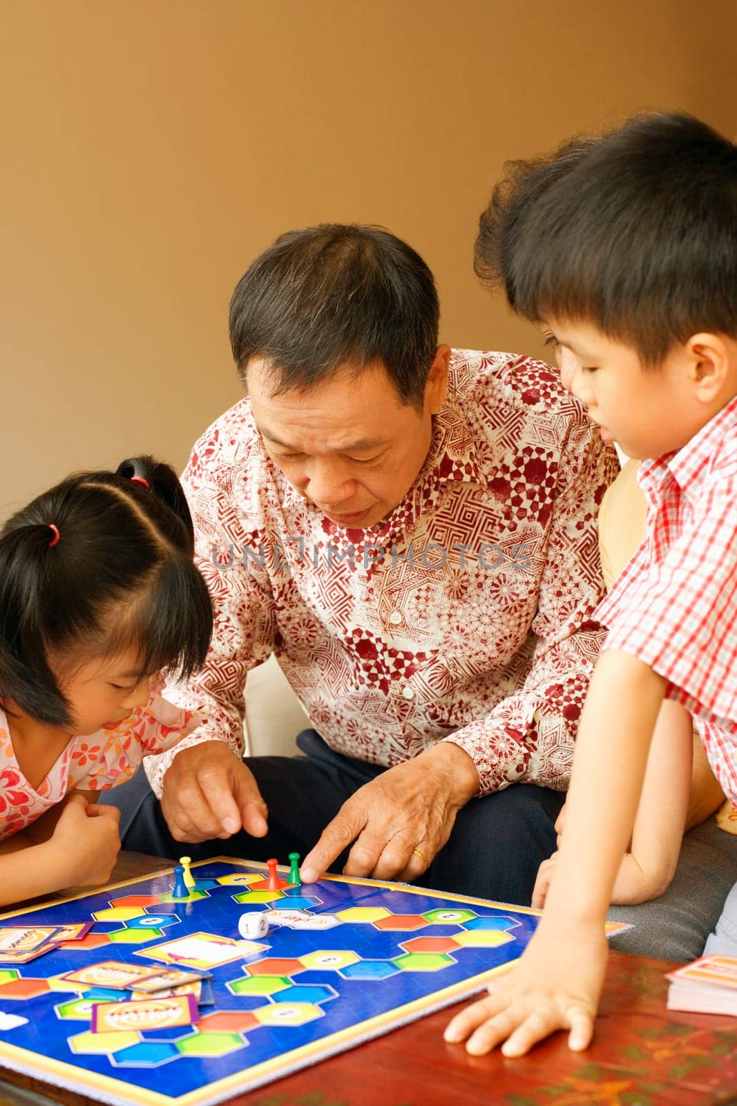 Close-up of a senior man playing a game with his grandchildren