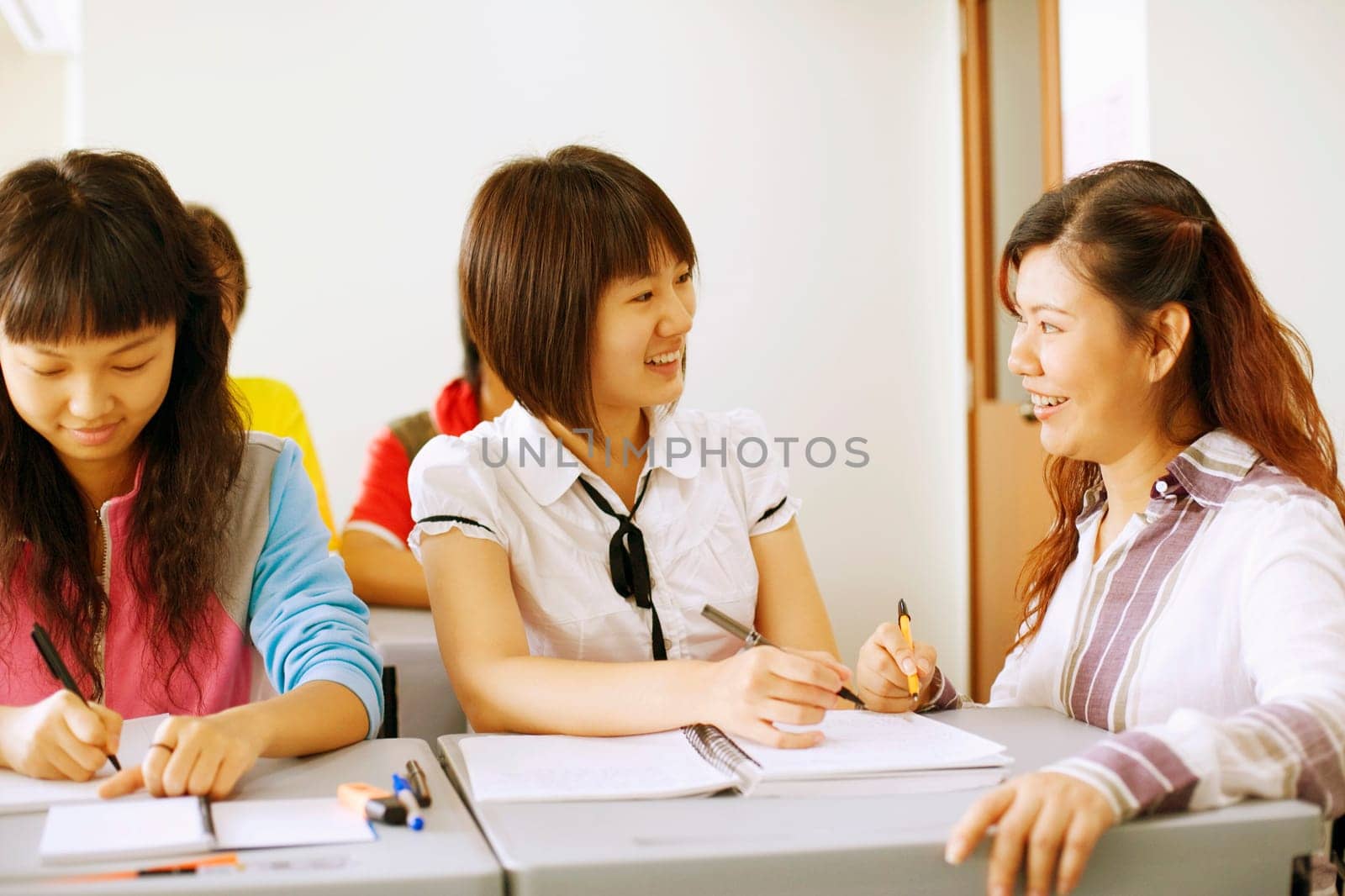 Close-up of a professor teaching her student in the classroom