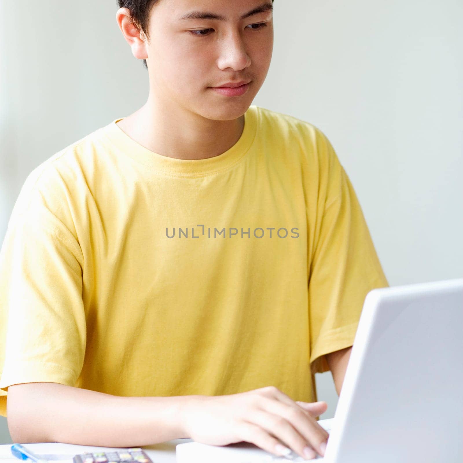 Close-up of a boy using a laptop