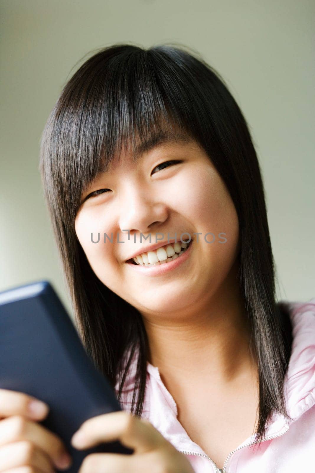 Portrait of a girl holding a video game and smiling