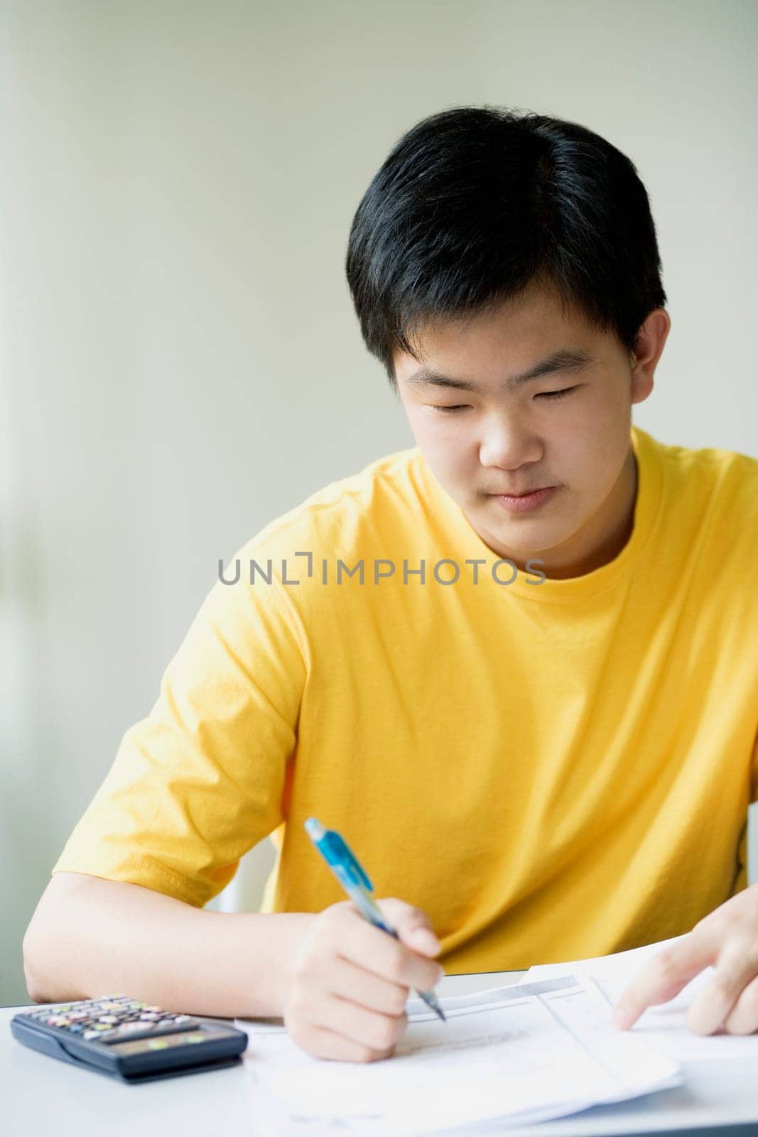 Close-up of a boy writing