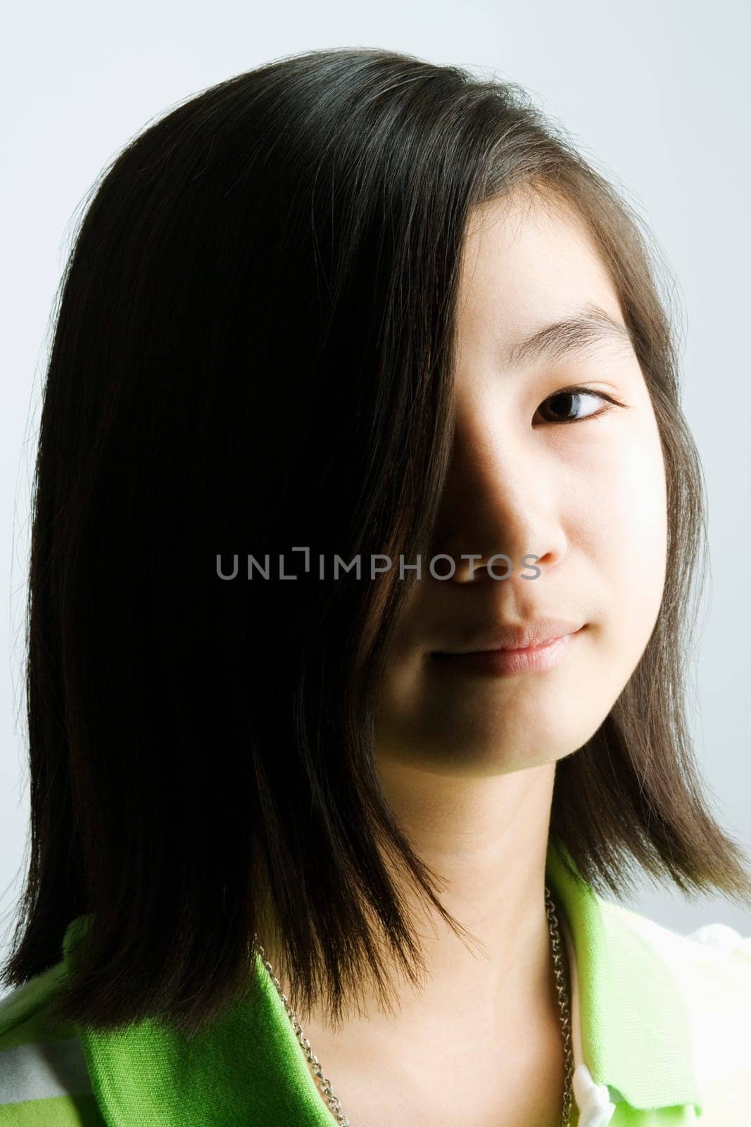 Portrait of a teenage girl with her hair covering her eye