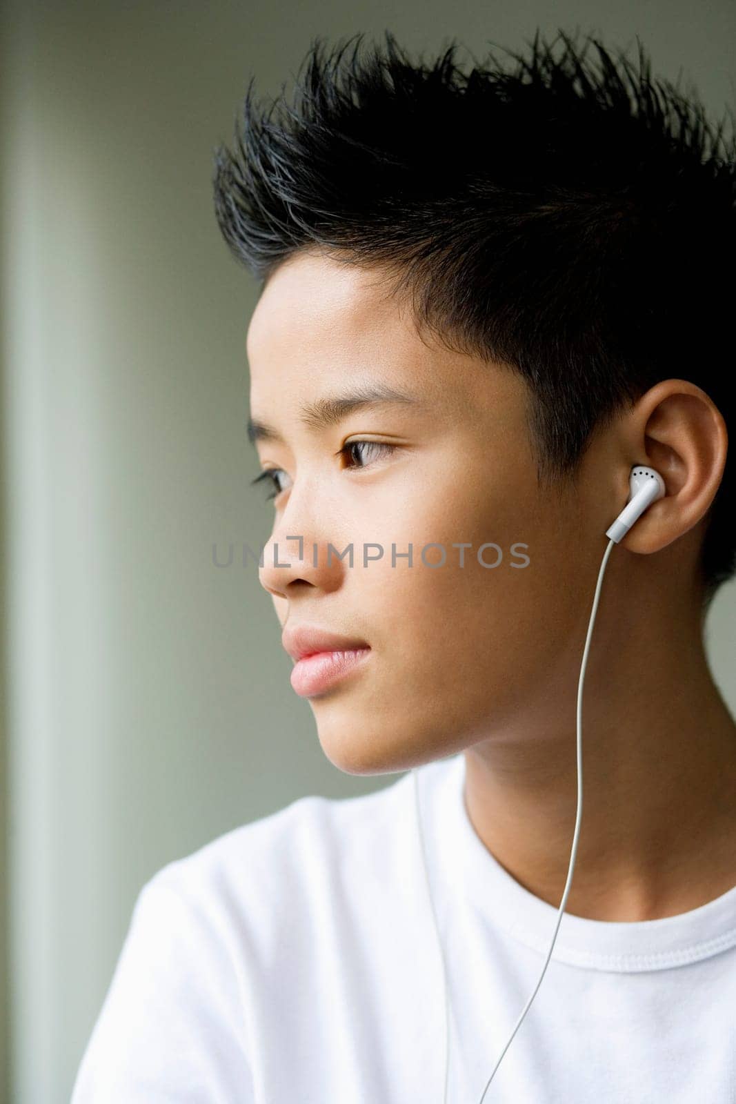 Side profile of a boy listening to headphones