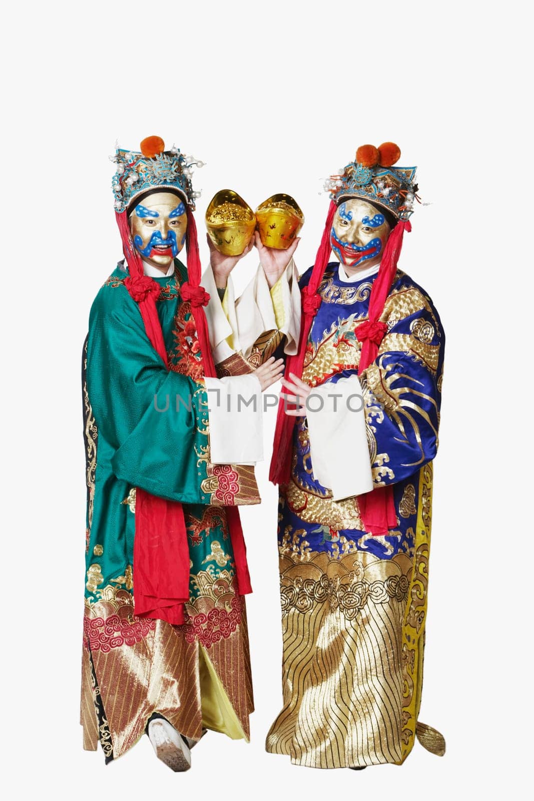 Portrait of two male Chinese opera performers holding bowls full of gold coins