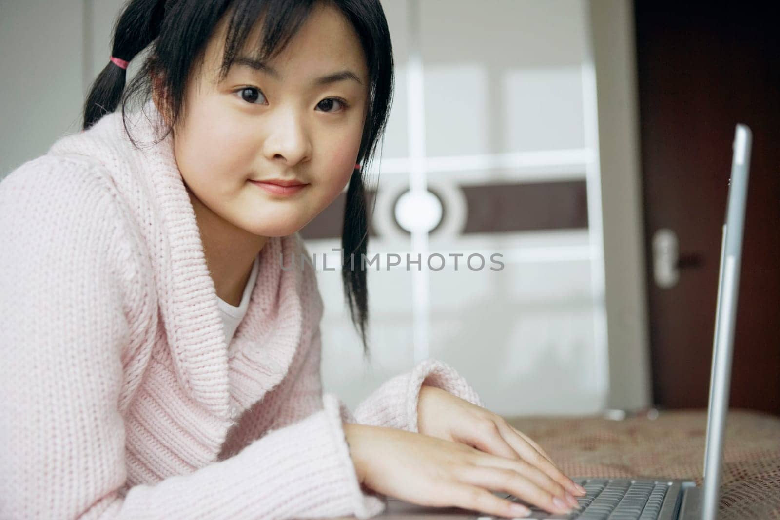 Portrait of a young woman using a laptop
