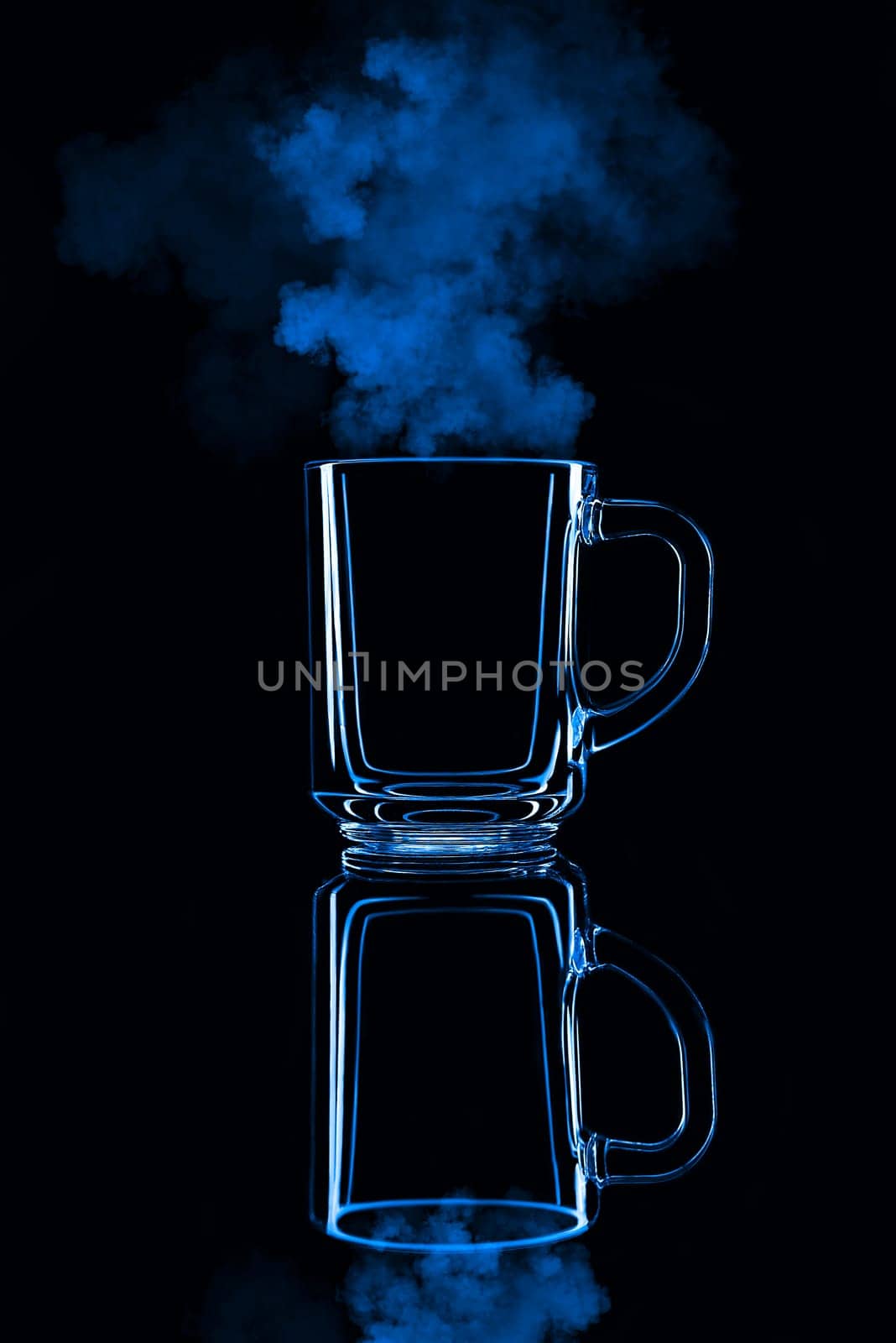 Just a glass on a black background with a reflection. Blue color, with steam. Isolated.