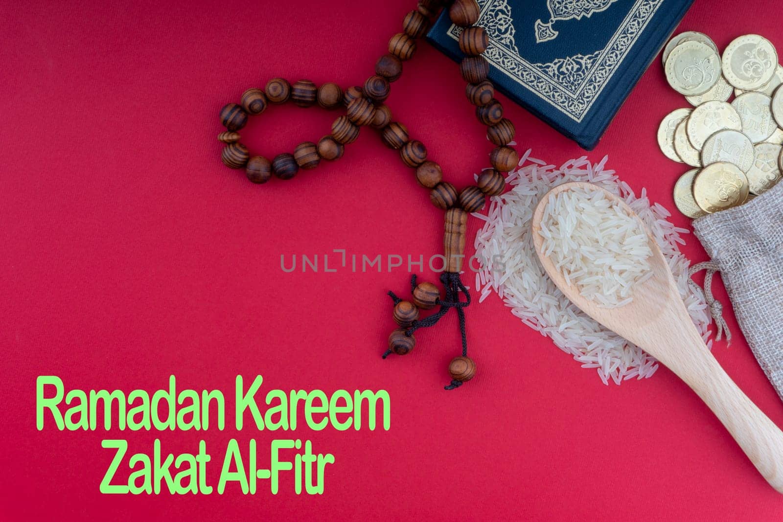 RAMADAN KAREEM ZAKAT AL FITR words with Holy Quran, Coins, Rosary and Rice. Zakat concept. Zakat is a form of alm-giving as a religious obligation
