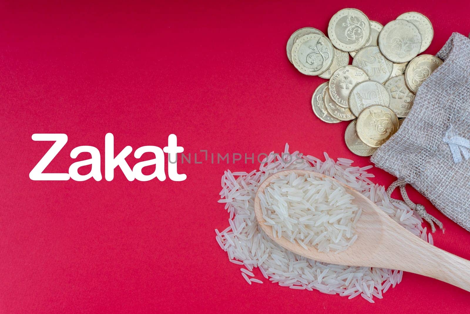 ZAKAT words with Coins and Rice on red background. Zakat concept. Zakat is a form of alm-giving as a religious obligation