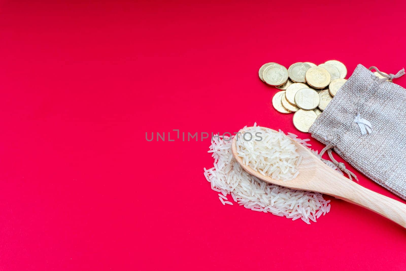 Coins and rice on red background. Zakat concept. Zakat is a form of alm-giving as a religious obligation