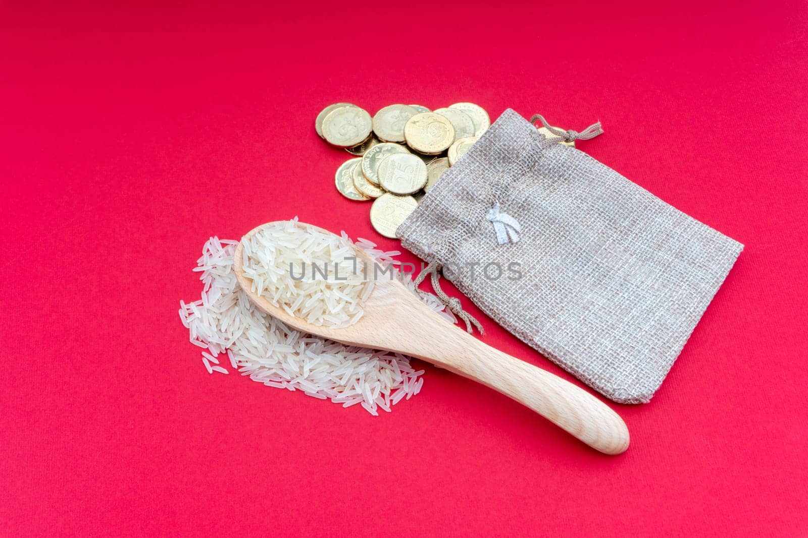 Coins and rice on red background. Zakat concept. Zakat is a form of alm-giving as a religious obligation