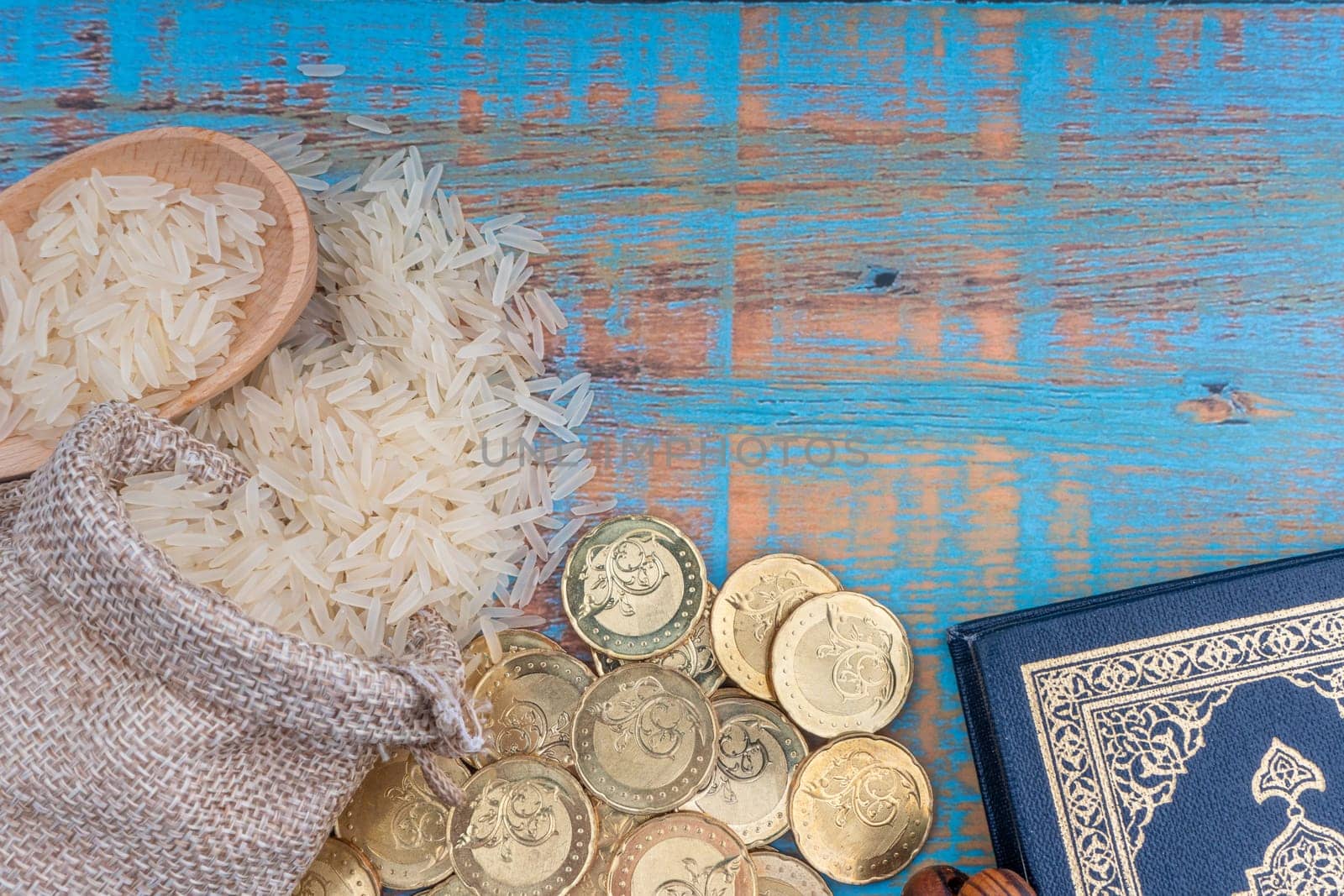 Holy Quran, Coins, Rosary and Rice. Zakat concept. Zakat is a form of alm-giving as a religious obligation
