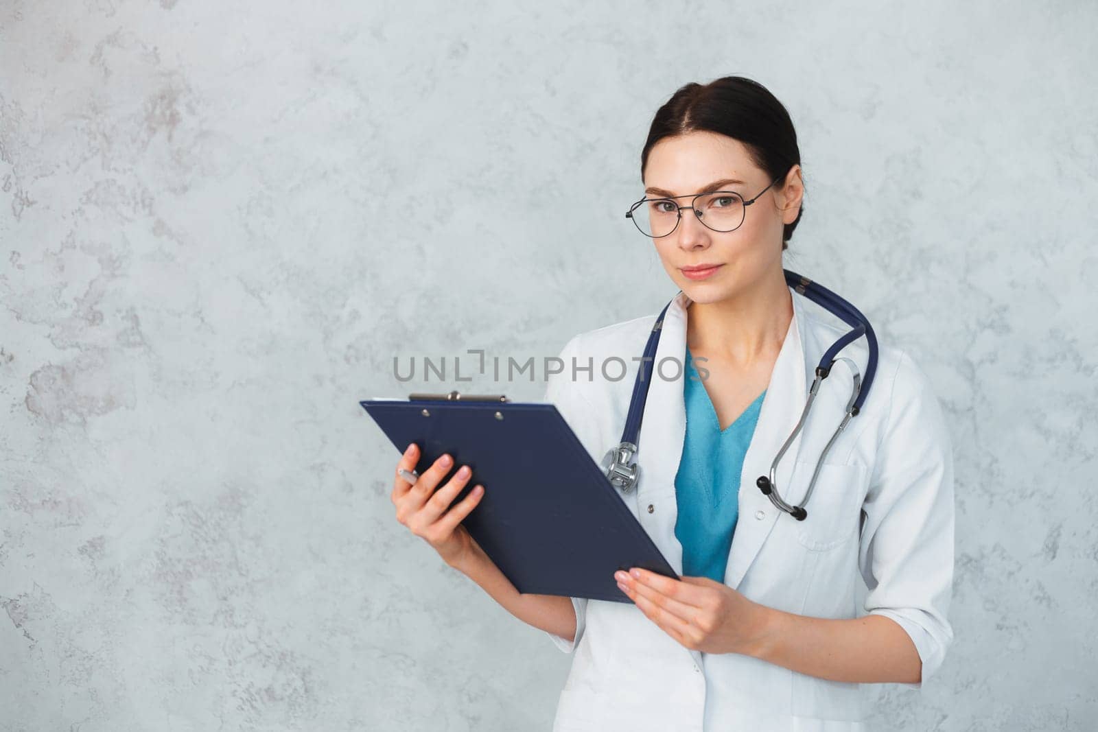Young female doctor with stethoscope and folder. caucasian brunette.