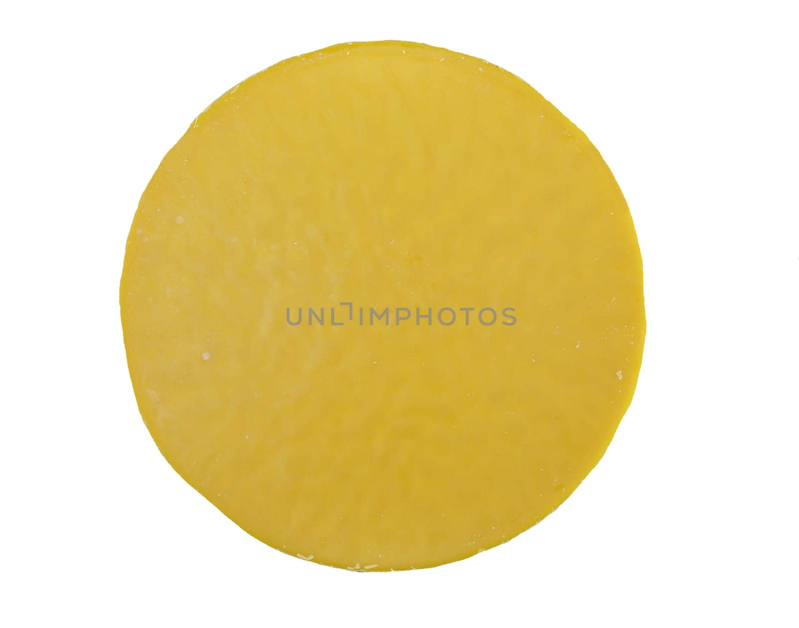 Round yellow wax block isolated