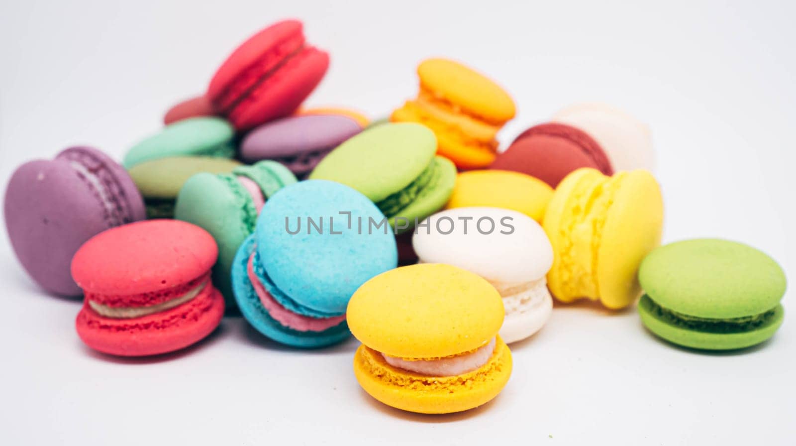 Pastel colored macarons sweet French dessert isolated on white background.